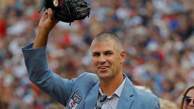 Joe Mauer waves with mitt